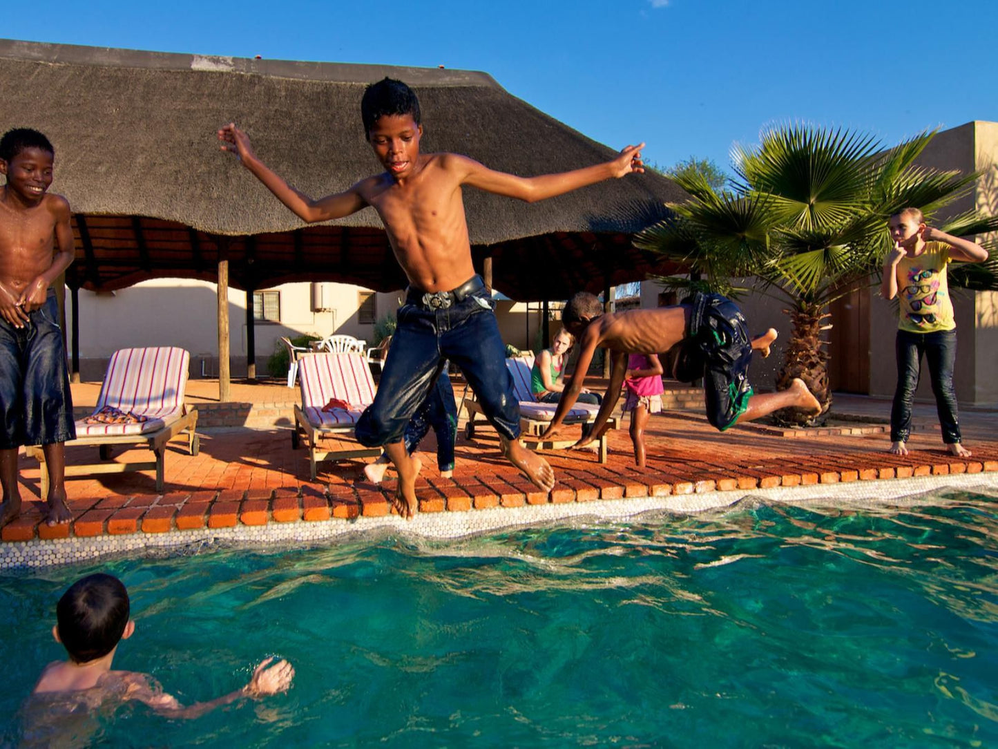 Kashana Namibia, Face, Person, Three Faces, Group, Swimming Pool, Frontal Face, Male, Child, Eyes Closed, Smile